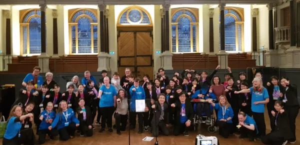 Group photo of soundabout choir members with the Body percussion ensemble